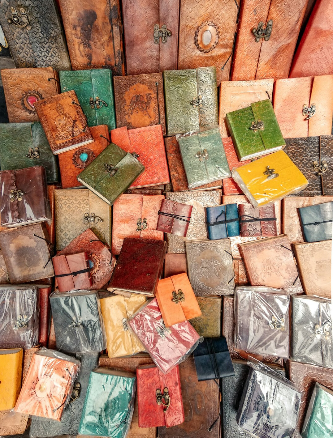 Stack of old leather-bound notebooks and journals