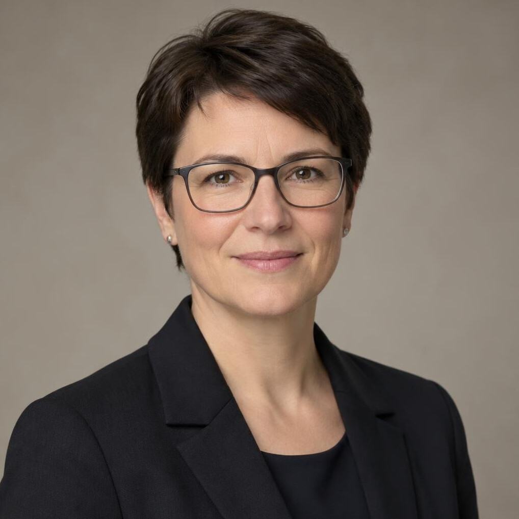 Studio portrait of a German woman in her forties with glasses